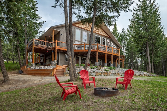 277 Ridge Loop Rd, Rexford, MT 59930 - rear view of house featuring an outdoor fire pit, a wooden deck, and stairs