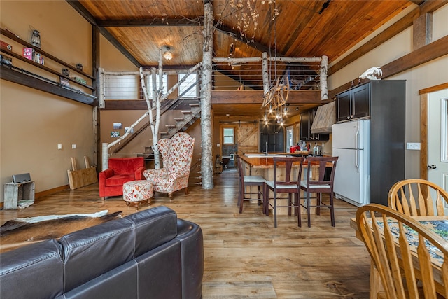 277 Ridge Loop Rd, Rexford, MT 59930 - living area featuring wooden ceiling with exposed beams, light wood finished floors, stairway, and high vaulted ceiling
