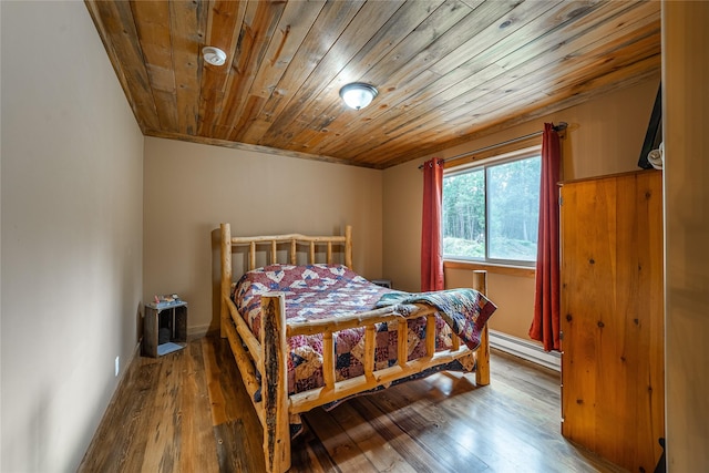 277 Ridge Loop Rd, Rexford, MT 59930 - bedroom featuring a baseboard heating unit, wood-type flooring, and wood ceiling