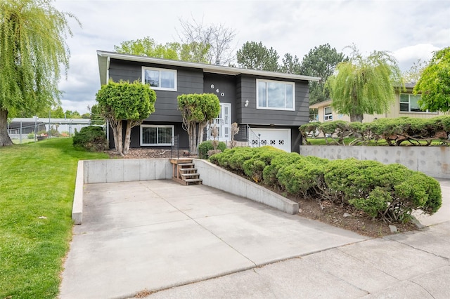 640 W Crestline Dr, Missoula, MT 59803 - split foyer home with a front lawn and an attached garage