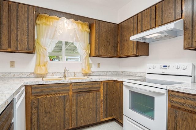 640 W Crestline Dr, Missoula, MT 59803 - kitchen with white range with electric cooktop, under cabinet range hood, a sink, and light countertops