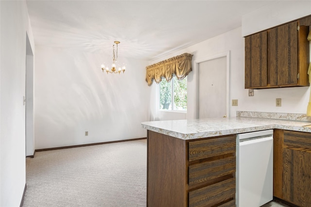640 W Crestline Dr, Missoula, MT 59803 - kitchen featuring white dishwasher, light colored carpet, a chandelier, light countertops, and a peninsula