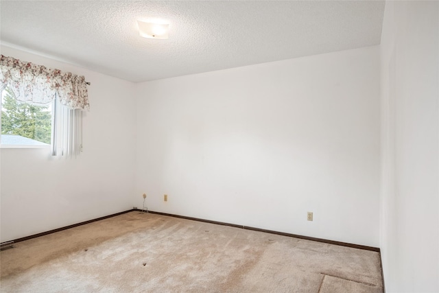 640 W Crestline Dr, Missoula, MT 59803 - spare room featuring carpet flooring, a textured ceiling, and baseboards