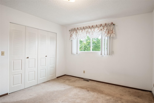 640 W Crestline Dr, Missoula, MT 59803 - unfurnished bedroom featuring carpet flooring, a closet, baseboards, and a textured ceiling