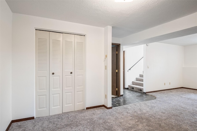 640 W Crestline Dr, Missoula, MT 59803 - unfurnished bedroom with carpet, a closet, baseboards, and a textured ceiling