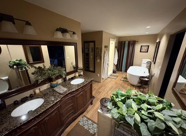 614 Johnson Ln, Superior, MT 59872 - bathroom with wood finished floors, a freestanding tub, and double vanity