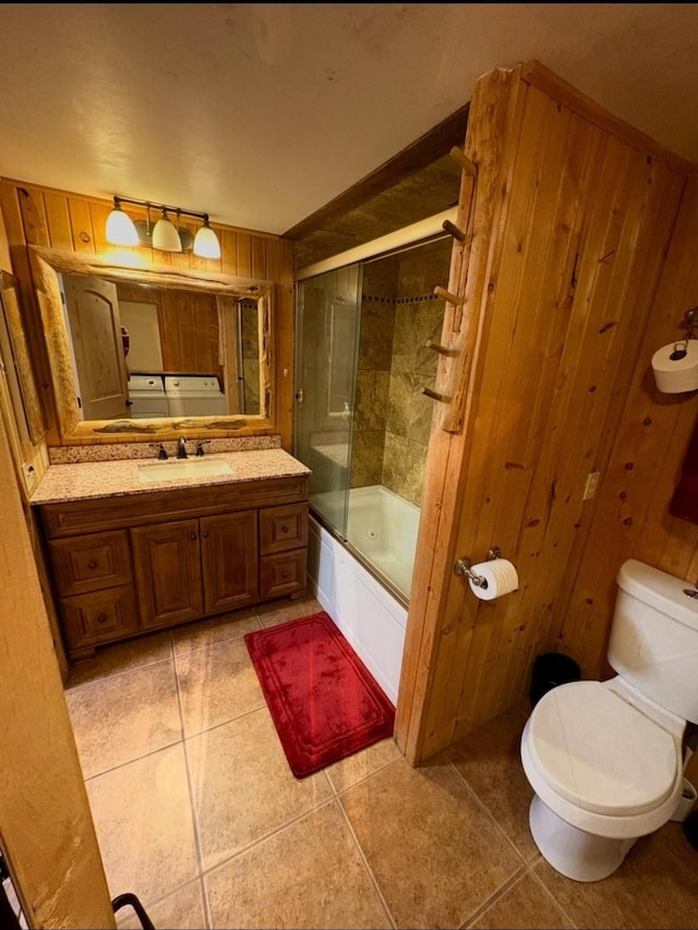614 Johnson Ln, Superior, MT 59872 - full bath with toilet, vanity, shower / bath combination with glass door, tile patterned floors, and wooden walls