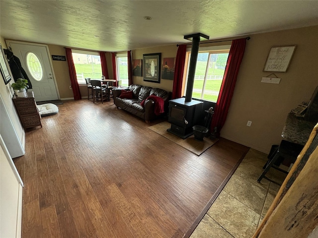 614 Johnson Ln, Superior, MT 59872 - living area featuring a wood stove, wood finished floors, and baseboards