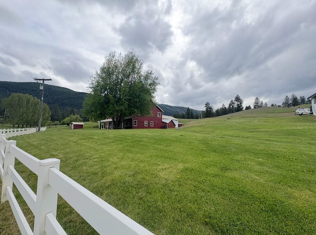 614 Johnson Ln, Superior, MT 59872 - view of yard featuring a mountain view, a view of countryside, an outbuilding, and a barn