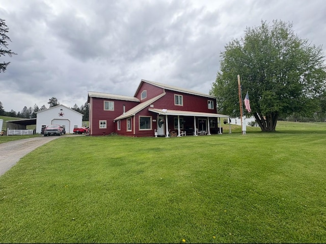 614 Johnson Ln, Superior, MT 59872 - view of front of house featuring an outdoor structure, a front lawn, driveway, and a detached garage