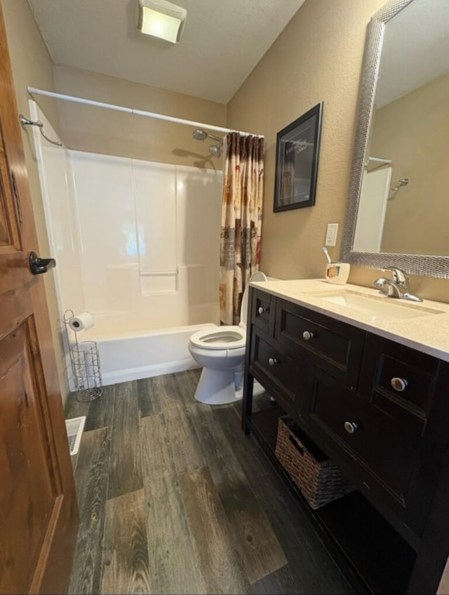 614 Johnson Ln, Superior, MT 59872 - bathroom with toilet, wood finished floors, vanity, and shower / tub combo with curtain