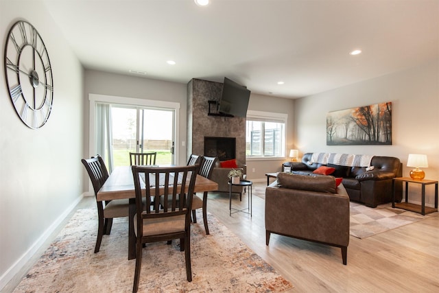 4394 Brookside Ln, Bozeman, MT 59718 - dining room with baseboards, light wood finished floors, recessed lighting, and a fireplace