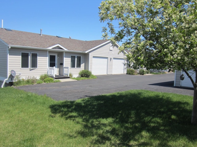 2220 Alpine Dr, Helena, MT 59601 - ranch-style house with a front lawn, an attached garage, a shingled roof, and asphalt driveway