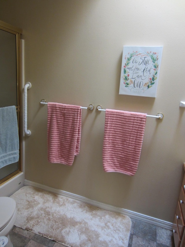 2220 Alpine Dr, Helena, MT 59601 - bathroom with toilet, vanity, a shower with door, and baseboards