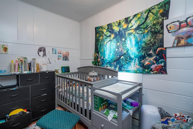 705 3rd St W, Polson, MT 59860 - bedroom with a decorative wall and a textured ceiling