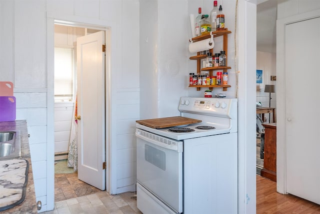 705 3rd St W, Polson, MT 59860 - kitchen with white range with electric cooktop, open shelves, and a sink