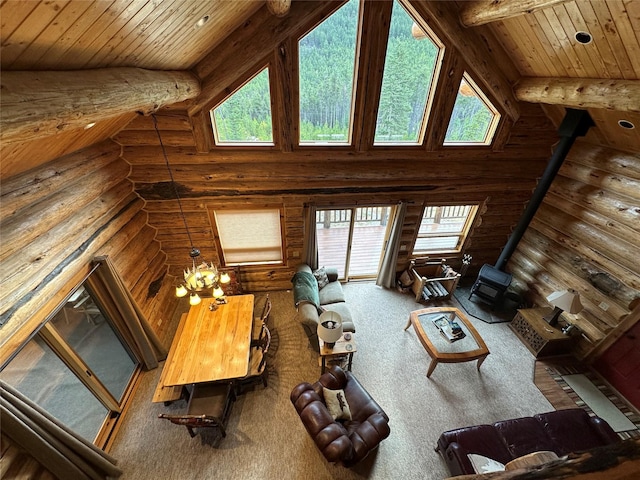 3966 Main Boulder Rd, Big Timber, MT 59011 - living area with rustic walls, a wood stove, plenty of natural light, wooden ceiling with exposed beams, and carpet flooring