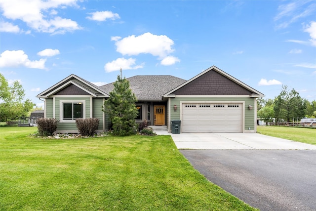 10 Canyon Breeze Ct, Stevensville, MT 59870 - view of front of property featuring asphalt driveway, a garage, and a front lawn