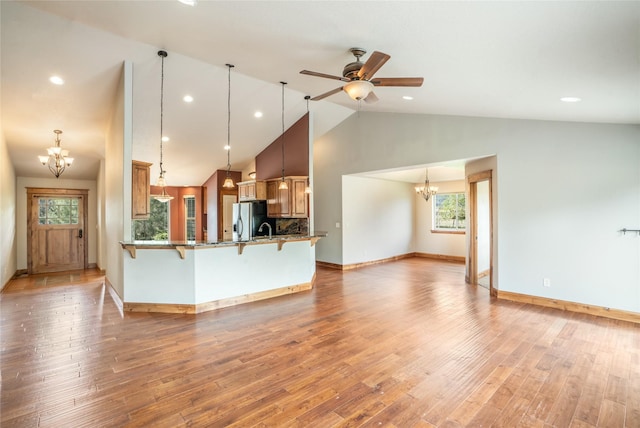 10 Canyon Breeze Ct, Stevensville, MT 59870 - kitchen with a chandelier, stainless steel fridge with ice dispenser, a kitchen bar, a peninsula, and a ceiling fan