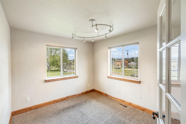 10 Canyon Breeze Ct, Stevensville, MT 59870 - carpeted spare room with baseboards and a textured ceiling
