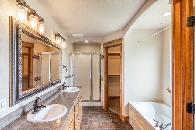 10 Canyon Breeze Ct, Stevensville, MT 59870 - full bath featuring a stall shower, a spacious closet, a bath, double vanity, and baseboards