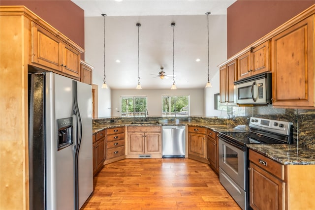 10 Canyon Breeze Ct, Stevensville, MT 59870 - kitchen featuring appliances with stainless steel finishes, a sink, light wood-style flooring, and brown cabinets