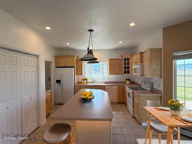 4160 Geneva Ln, Butte, MT 59701 - kitchen with white appliances, light brown cabinetry, a center island, glass insert cabinets, and light tile patterned floors