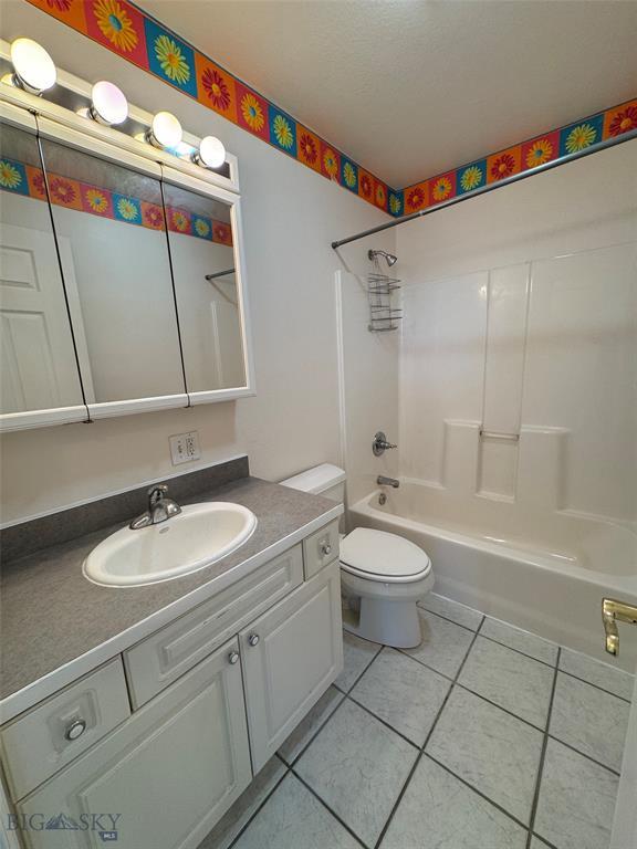 4160 Geneva Ln, Butte, MT 59701 - full bathroom with tile patterned flooring,  shower combination, vanity, and toilet