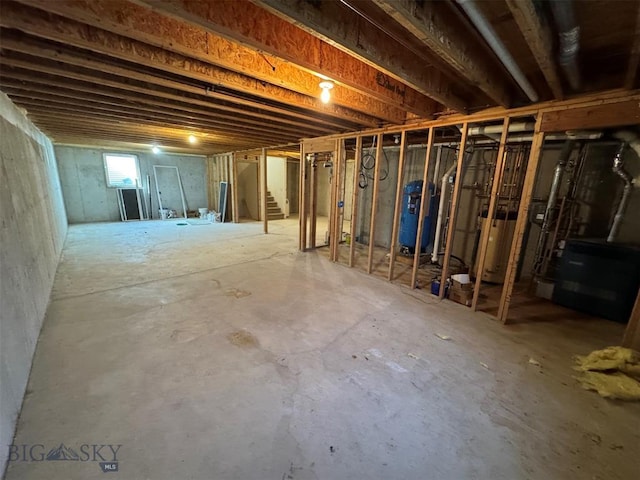 4160 Geneva Ln, Butte, MT 59701 - below grade area featuring water heater, a water pressure tank, and stairs
