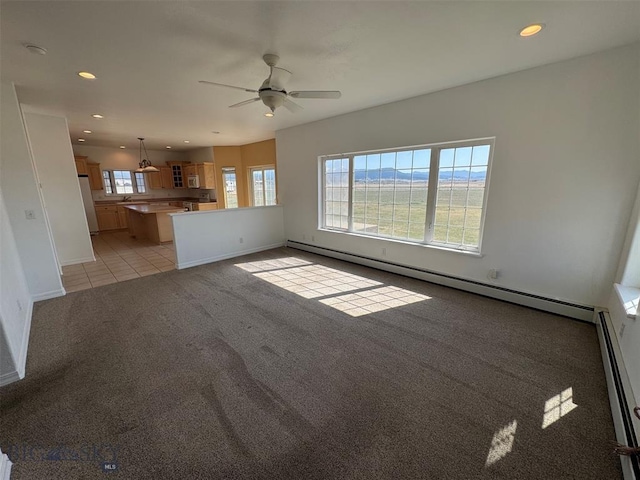 4160 Geneva Ln, Butte, MT 59701 - unfurnished living room with light colored carpet, recessed lighting, baseboards, a baseboard heating unit, and a ceiling fan