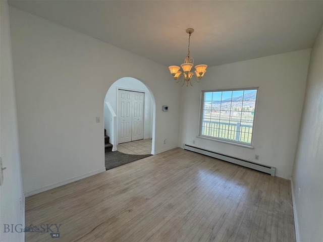 4160 Geneva Ln, Butte, MT 59701 - empty room with a baseboard radiator, arched walkways, hardwood / wood-style floors, a chandelier, and stairs