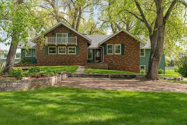 70 Dune Hill Ln, Great Falls, MT 59404 - view of front of home featuring a balcony, brick siding, and a front lawn