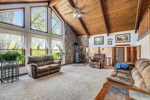 70 Dune Hill Ln, Great Falls, MT 59404 - carpeted living room featuring a wood stove, wooden ceiling with exposed beams, high vaulted ceiling, and ceiling fan