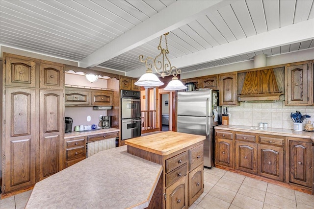 70 Dune Hill Ln, Great Falls, MT 59404 - kitchen with freestanding refrigerator, double oven, light tile patterned flooring, butcher block countertops, and decorative backsplash