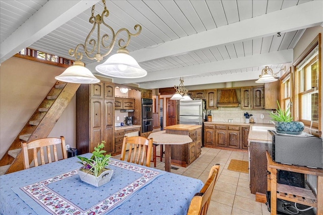 70 Dune Hill Ln, Great Falls, MT 59404 - dining room with light tile patterned flooring and wood ceiling with exposed beams