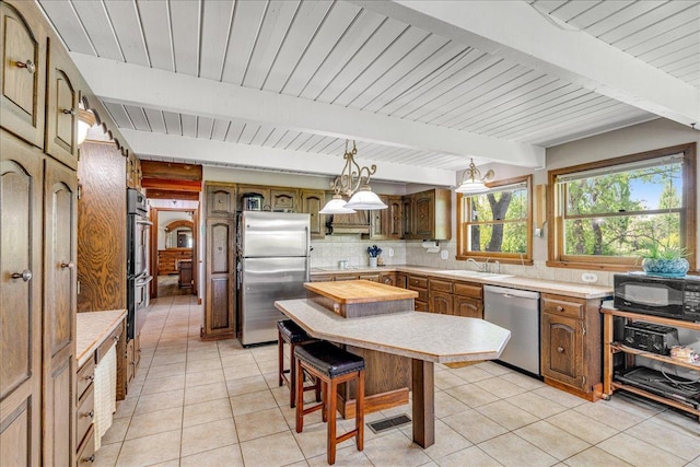 70 Dune Hill Ln, Great Falls, MT 59404 - kitchen featuring stainless steel appliances, a sink, light countertops, decorative backsplash, and light tile patterned floors