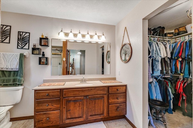 70 Dune Hill Ln, Great Falls, MT 59404 - bathroom featuring toilet, vanity, and a walk in closet