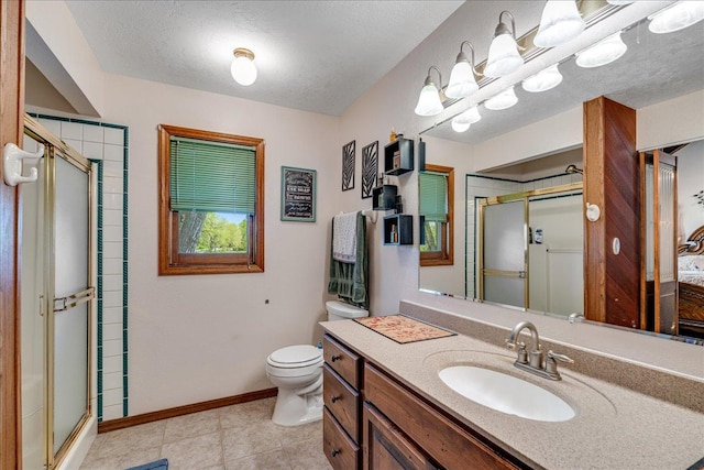 70 Dune Hill Ln, Great Falls, MT 59404 - bathroom featuring a shower stall, toilet, vanity, a textured ceiling, and baseboards