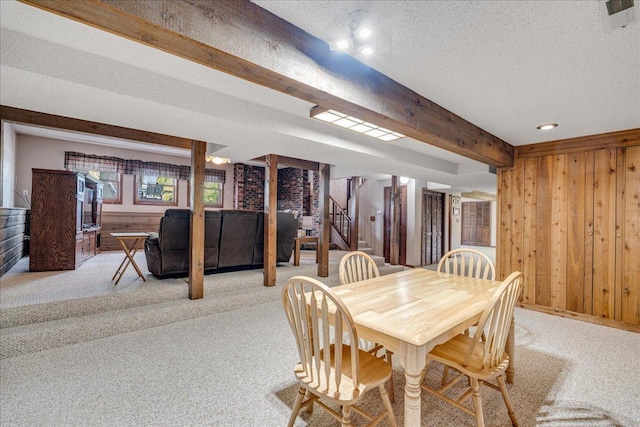 70 Dune Hill Ln, Great Falls, MT 59404 - dining room featuring stairway, wood walls, light carpet, beam ceiling, and a textured ceiling