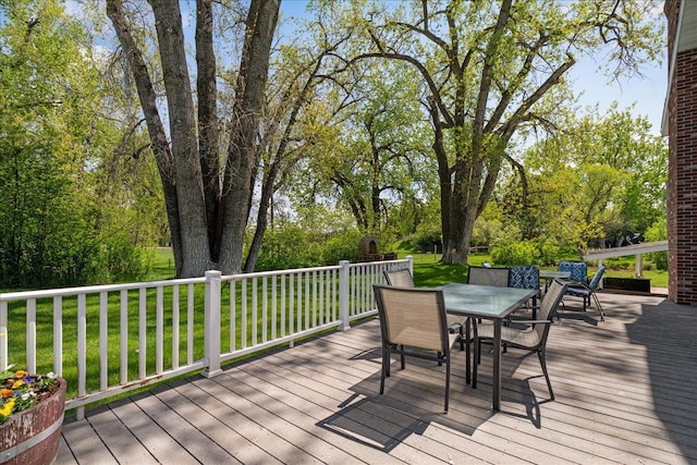 70 Dune Hill Ln, Great Falls, MT 59404 - deck featuring outdoor dining space, a lawn, and view of scattered trees