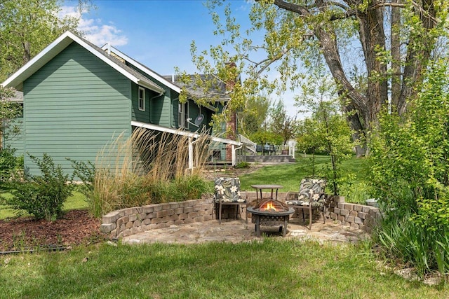 70 Dune Hill Ln, Great Falls, MT 59404 - view of green lawn featuring an outdoor fire pit and a patio area