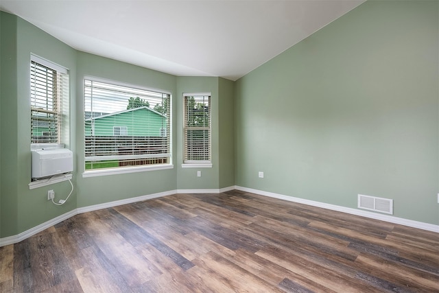 1605 Lund Ln, Polson, MT 59860 - spare room with wood finished floors, baseboards, lofted ceiling, and cooling unit
