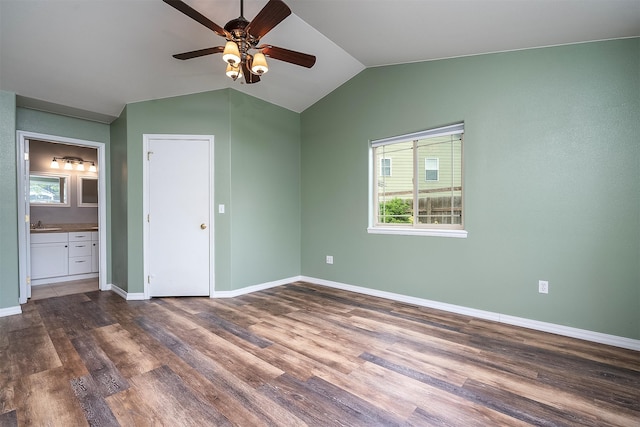 1605 Lund Ln, Polson, MT 59860 - unfurnished bedroom featuring lofted ceiling, dark wood-style floors, baseboards, connected bathroom, and ceiling fan