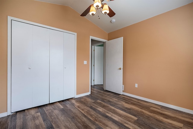 1605 Lund Ln, Polson, MT 59860 - unfurnished bedroom featuring dark wood-style floors, lofted ceiling, baseboards, a closet, and a ceiling fan