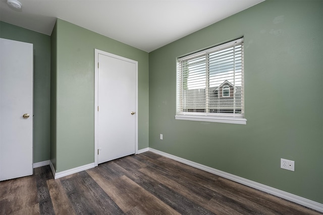 1605 Lund Ln, Polson, MT 59860 - unfurnished bedroom featuring wood finished floors and baseboards