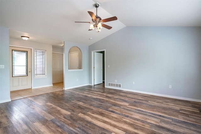 1605 Lund Ln, Polson, MT 59860 - unfurnished room with ceiling fan, vaulted ceiling, wood finished floors, and baseboards