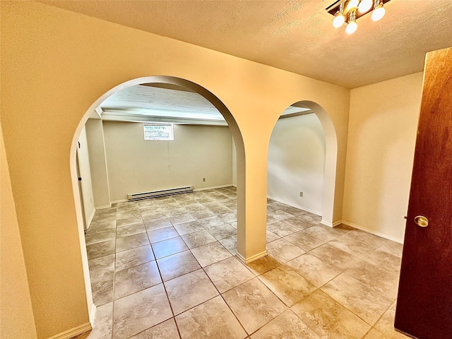 310 W Armitage St, Ennis, MT 59729 - entryway featuring baseboard heating, arched walkways, a textured ceiling, light tile patterned floors, and baseboards