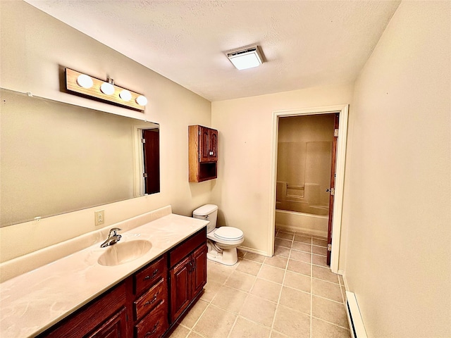 310 W Armitage St, Ennis, MT 59729 - bathroom featuring vanity, a baseboard heating unit, toilet, a bath, and tile patterned floors
