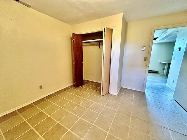 310 W Armitage St, Ennis, MT 59729 - unfurnished bedroom featuring light tile patterned floors, a closet, and baseboards