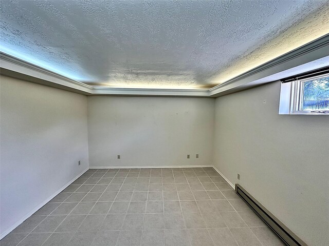 310 W Armitage St, Ennis, MT 59729 - basement with a baseboard heating unit, a textured ceiling, and baseboards